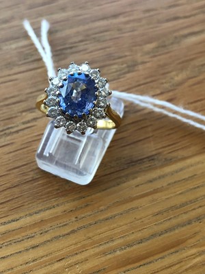 Lot 75 - An 18ct gold Sri Lankan sapphire and diamond cluster ring