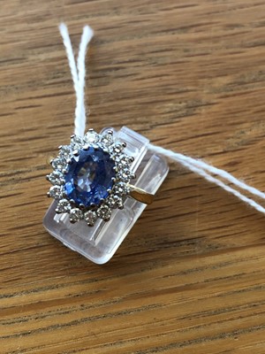 Lot 75 - An 18ct gold Sri Lankan sapphire and diamond cluster ring