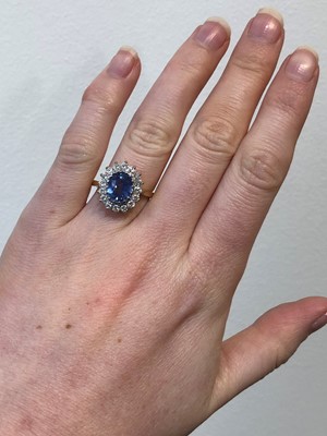 Lot 75 - An 18ct gold Sri Lankan sapphire and diamond cluster ring