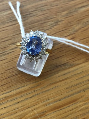 Lot 75 - An 18ct gold Sri Lankan sapphire and diamond cluster ring