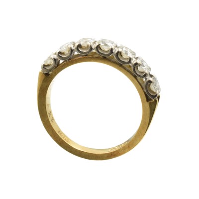 Lot 74 - A 7-stone diamond and gold half eternity ring
