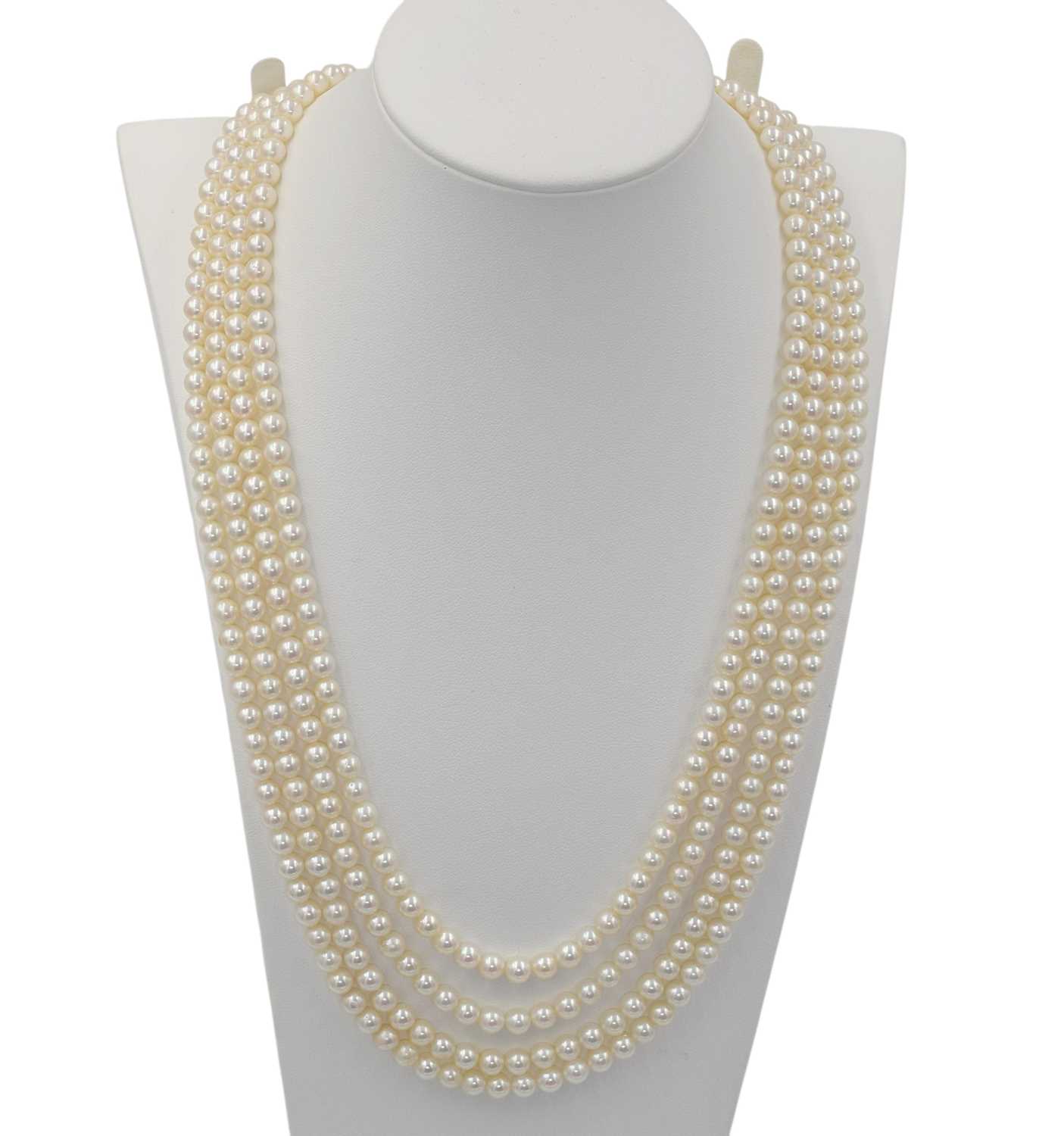 Lot A four-row akoya pearl necklace with a white gold and diamond clasp
