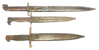 Lot 294 - Three bayonets and scabbards, to include a...