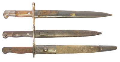 Lot 297 - Three bayonets and scabbards, to include a...