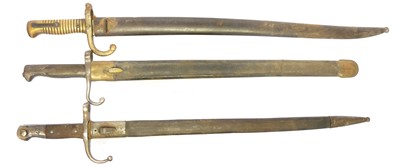 Lot 299 - Three bayonets and scabbards, to include a...