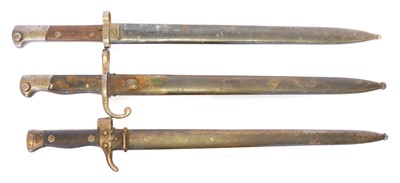 Lot 301 - Three bayonets and scabbards, to include an...