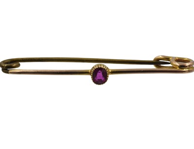 Lot A yellow metal and ruby brooch