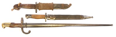 Lot Three bayonets and scabbards, to include a...