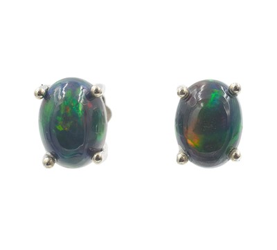 Lot 34 - A pair of oval cabochon black opal studs in silver