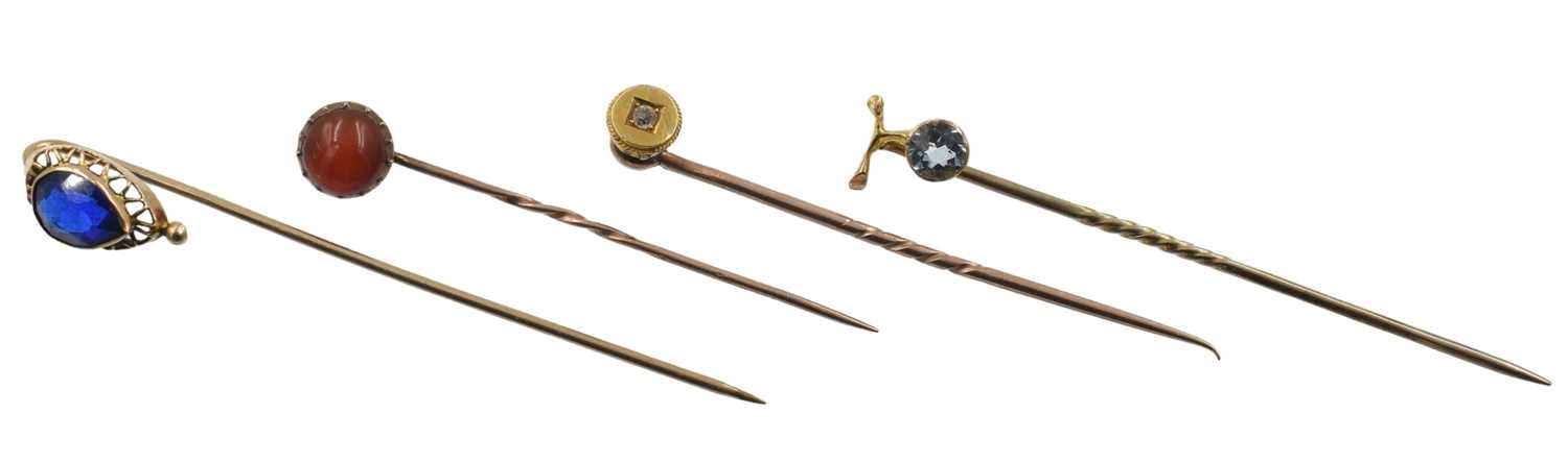 Lot A selection of four yellow metal stick pins