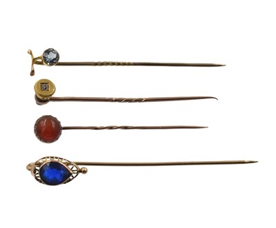 Lot A selection of four yellow metal stick pins