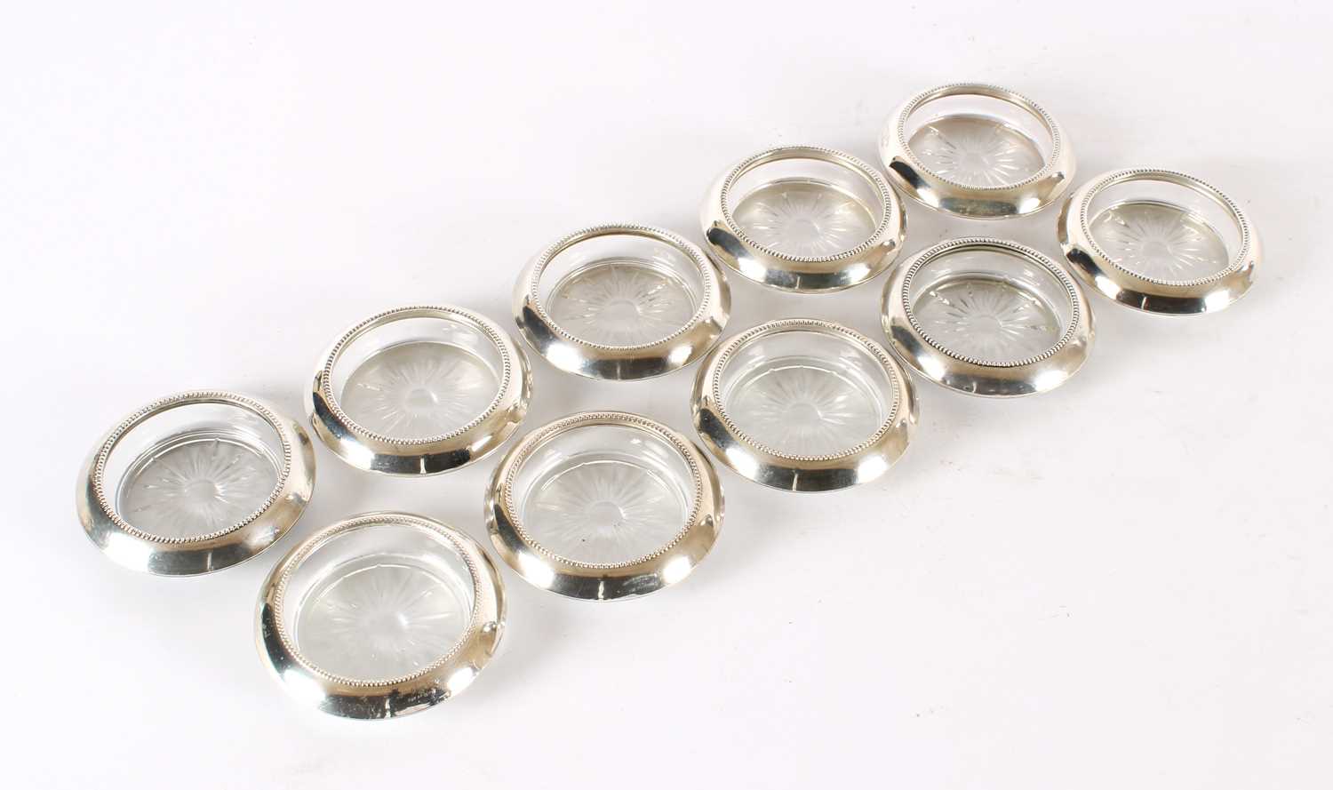 Lot 19 - A Set of Ten Early 20th Century American Sterling Silver Mounted Clear Glass Coasters