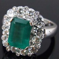 Lot 381 - Emerald and diamond cushion cluster ring, the