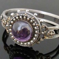 Lot 405 - French silver and gold hinged bangle, circa 1900