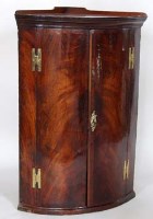 Lot 686 - George III mahogany wall hanging bow fronted corner cupboard